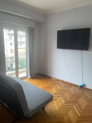 a room with a bed and a flat screen tv at 45 τμ διαμέρισμα in Athens