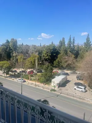 a view of a road with cars parked in a parking lot at 45 τμ διαμέρισμα in Athens
