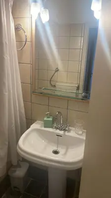 a bathroom with a sink and a mirror and a toilet at 45 τμ διαμέρισμα in Athens