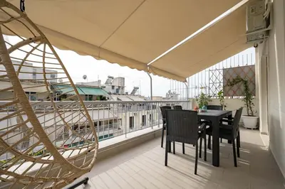 a balcony with a table and chairs on a balcony at Kypseli Pulse 2BR Residence by ΜΡS in Athens
