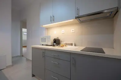 a kitchen with a sink and a microwave at Kypseli Pulse 2BR Residence by ΜΡS in Athens