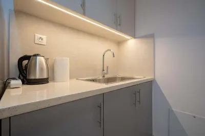 a kitchen with a sink and a kettle on a counter at Kypseli Pulse 2BR Residence by ΜΡS in Athens
