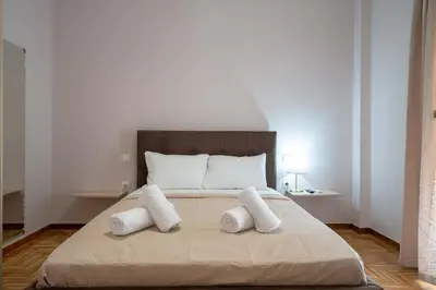 a bedroom with a large bed with two pillows at Kypseli Pulse 2BR Residence by ΜΡS in Athens