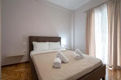 a bedroom with a large bed with towels on it at Kypseli Pulse 2BR Residence by ΜΡS in Athens