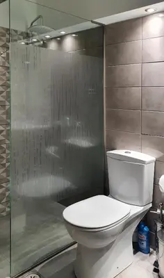 a bathroom with a toilet and a glass shower at Harmonia in Athens