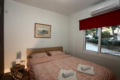 a bedroom with a bed with two towels on it at Harmonia in Athens