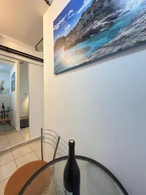 a wine bottle sitting on a glass table in a room at New Place Athens in Athens