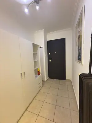 a hallway with a black door and a tiled floor at New Place Athens in Athens