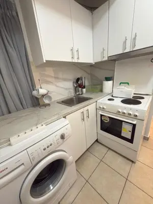 a kitchen with a washing machine and a sink at New Place Athens in Athens