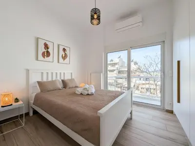 a bedroom with a bed with a stuffed animal on it at Acropolis view 2BD top floor next to tram and port in Piraeus
