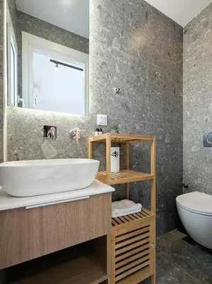 a bathroom with a white sink and a toilet at Acropolis view 2BD top floor next to tram and port in Piraeus