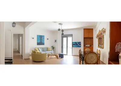 a living room with a couch and a table at Bright Urban Retreat in Athens in Athens