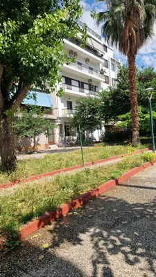a street with a palm tree and a building at Bright Urban Retreat in Athens in Athens