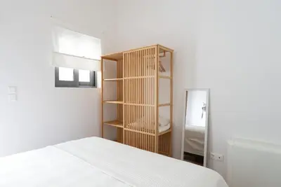a bedroom with a bed and a book shelf at Bright Urban Retreat in Athens in Athens