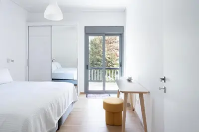 a bedroom with a bed and a desk and a window at Bright Urban Retreat in Athens in Athens