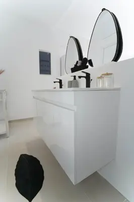 a bathroom with a white sink and a mirror at Moschato modern cozy apartment with private yard in Piraeus