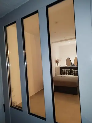 a sliding glass door leading into a room with a bed at Moschato modern cozy apartment with private yard in Piraeus