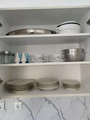 a shelf filled with plates and bowls and dishes at Moschato modern cozy apartment with private yard in Piraeus