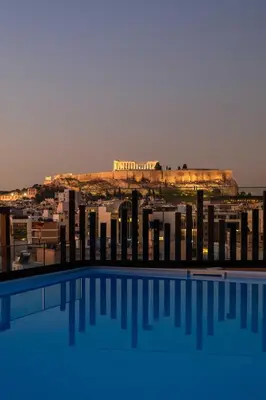 a view of a city from a swimming pool at Thea Acropolis Suites & Apartments in Athens