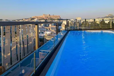 a swimming pool on the balcony of a building at Thea Acropolis Suites & Apartments in Athens