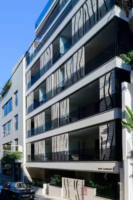 an apartment building with a car parked in front of it at Thea Acropolis Suites & Apartments in Athens