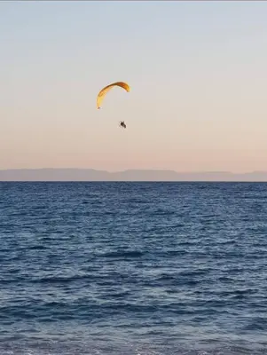 a kite flying over a body of water at Athens Glyfada Luxury Loft Swimming Pool fully equipped all new in Athens