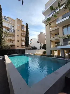 a swimming pool in front of a building at Athens Glyfada Luxury Loft Swimming Pool fully equipped all new in Athens