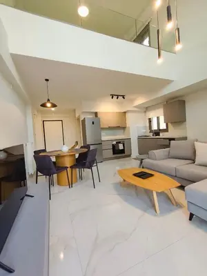 a living room with a couch and a table at Athens Glyfada Luxury Loft Swimming Pool fully equipped all new in Athens