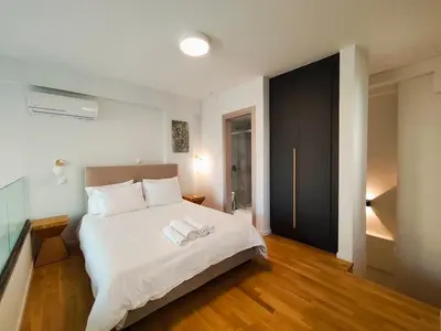 a bedroom with a bed with two towels on it at Athens Glyfada Luxury Loft Swimming Pool fully equipped all new in Athens