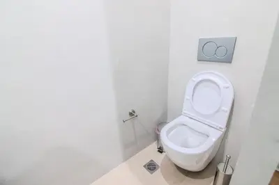 a bathroom with a toilet in a white room at Monastiraki Center Stay in Athens