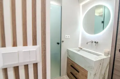 a bathroom with a sink and a mirror at Monastiraki Center Stay in Athens