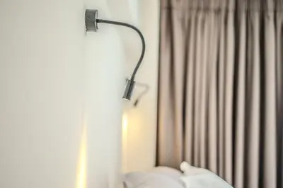 a lamp next to a window with a curtain at Monastiraki Center Stay in Athens