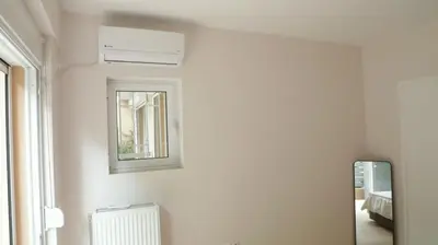 a white room with a mirror and a window at Luxury 1 Bd Apt with Patio in Neo Psychiko in Athens