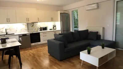 a living room with a couch and a table at Luxury 1 Bd Apt with Patio in Neo Psychiko in Athens