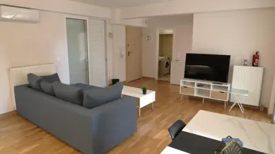 a living room with a couch and a tv at Luxury 1 Bd Apt with Patio in Neo Psychiko in Athens