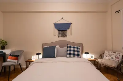 a bedroom with a bed and two chairs at Cozy 1BR Apt near Acropolis & Metro In Koukaki in Athens