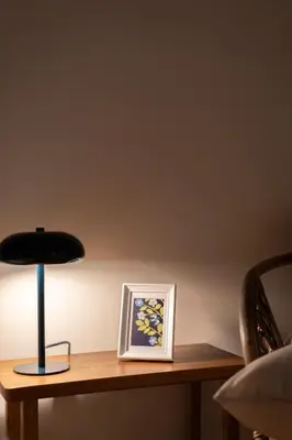 a lamp sitting on a table next to a picture at Cozy 1BR Apt near Acropolis & Metro In Koukaki in Athens