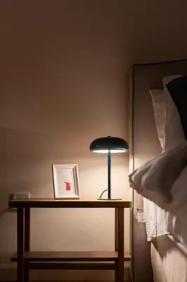 a lamp on a table next to a bed at Cozy 1BR Apt near Acropolis & Metro In Koukaki in Athens