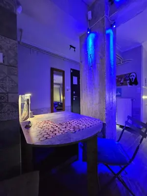 a table in a room with purple and blue lights at Μοντέρνο Ημιυπόγειο στουντιο διαμέρισμα στην Αθήνα με αυλή in Athens