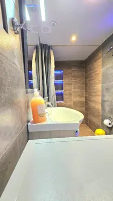 a bathroom with a sink and a large orange container on the counter at Μοντέρνο Ημιυπόγειο στουντιο διαμέρισμα στην Αθήνα με αυλή in Athens