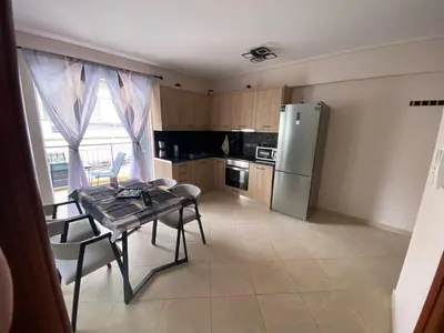 a kitchen with a table and a stainless steel refrigerator at Athens Luxury & Smart Center House - Free Parking - 300 Mbps Fiber Wi-Fi in Athens