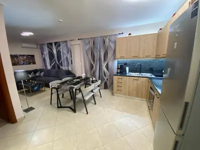 a kitchen and living room with a table and a couch at Athens Luxury & Smart Center House - Free Parking - 300 Mbps Fiber Wi-Fi in Athens
