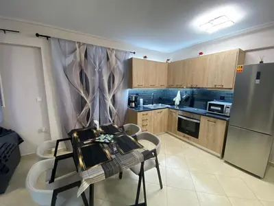 a kitchen with a table and chairs and a refrigerator at Athens Luxury & Smart Center House - Free Parking - 300 Mbps Fiber Wi-Fi in Athens