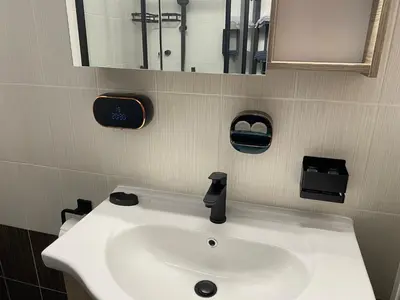 a bathroom with a white sink and a mirror at Athens Luxury & Smart Center House - Free Parking - 300 Mbps Fiber Wi-Fi in Athens