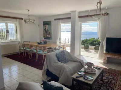 a living room with a table and a dining room at Art Blue Residence Maisonette in Aghia Marina