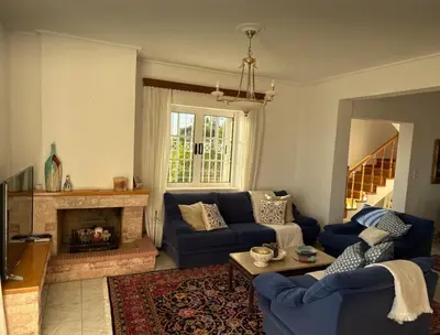 a living room with blue couches and a fireplace at Art Blue Residence Maisonette in Aghia Marina