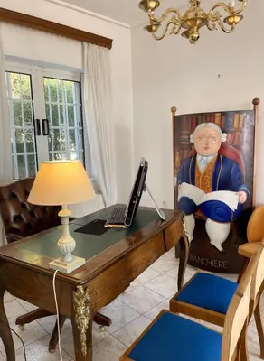 a living room with a desk with a laptop on it at Art Blue Residence Maisonette in Aghia Marina