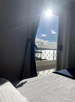 a bedroom with a bed and a view of the ocean at Art Blue Residence Maisonette in Aghia Marina