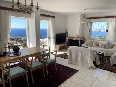a living room with a table and a couch at Art Blue Residence Maisonette in Aghia Marina