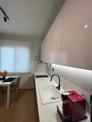 a kitchen with a sink and a red appliance on a counter at Thymeli Cozy Apartment in Athens